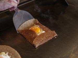 an egg in a piece of bread with a knife at WeBase KAMAKURA in Kamakura
