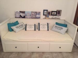 a white bench with pillows on it in a room at Argentario nice dreams in Porto Santo Stefano +5 photos