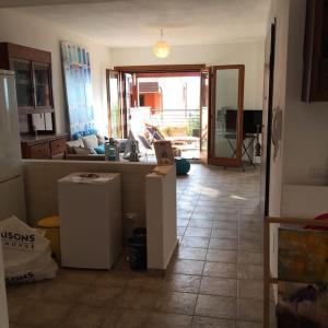a room with a kitchen and a living room at Argentario nice dreams in Porto Santo Stefano