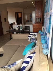 a couch with pillows on it in a living room at Argentario nice dreams in Porto Santo Stefano