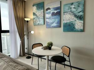 a living room with a white table and chairs at Urban Suites Cozy Home with Netflix and Board games in Jelutong