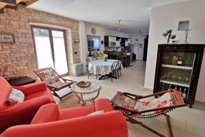 a living room with a red couch and a table at Casa Le Finide in Bale