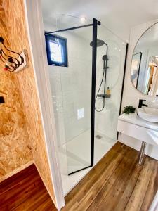 a glass shower in a bathroom with a sink at la suite conteneur in Septèmes-les-Vallons +5 photos