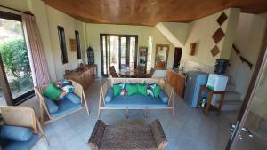 an aerial view of a living room with chairs and a kitchen at Lombok Villas, Villa PaoPao in Labuhanpoh