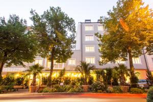 a large building with trees in front of it at BARDOLINO Fine.Food.Hotel in Nuremberg