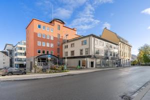 an empty street with buildings on the side of the road at Enter Amalie Apartment Hotel in Tromsø