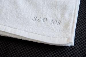 a white napkin with the words stitch on it at Apartamente by R S in Năvodari +144 photos