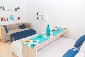 a living room with a table and a couch at C-suites Canberra in Bengaluru