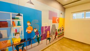 a room with a mural on the wall at C-suites Canberra in Bengaluru