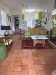a living room with a couch and a table at Dancers' Cottages in Cape Town
