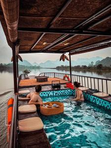 a group of people in a swimming pool on a river at Morning Calm Garden villa - Ninh binh in La Phù