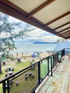 a balcony with a view of the beach at Seaside Cenang in Pantai Cenang