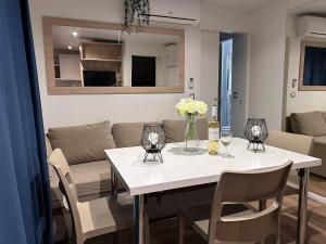 a living room with a table with flowers and a couch at Danyja Mobilehome in Biograd na Moru