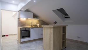 a kitchen with a sink and a counter in a room at New Moment Lux 2 in Žarkovo