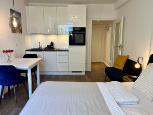 a kitchen and living room with a bed and a table at Beach&City Bude inkl Saisonstrandkorb in Grömitz