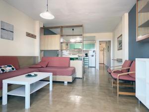 a living room with a couch and a table at Apartamentos Acuario in Denia