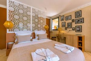 a bedroom with a bed with two towels on it at Villa Naël Marrakech in Marrakech