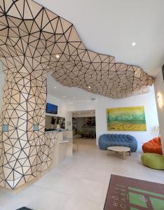 a living room with a geometric patterned wall at Hôtel Carré Vieux Port in Marseille
