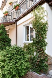 a building with ivy growing on the side of it at Nota Bene Hotel & Restaurant in Lviv +207 photos