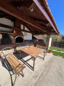 a picnic table and a bench under a pavilion at Casa Soporan in Cluj-Napoca