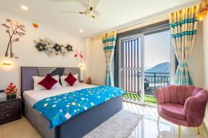 a bedroom with a bed and a window and a chair at Rizell Alexis in Shimla +63 photos