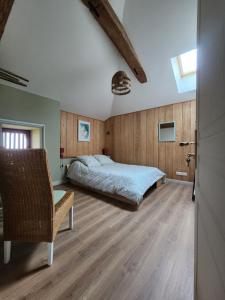a bedroom with a bed and a chair at Chambres d'hotes aux Petits Belézins in Saint-Amour +27 photos