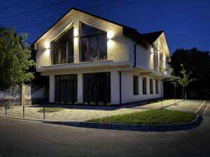 a large white building with windows on a street at Yu-home in Mukacheve