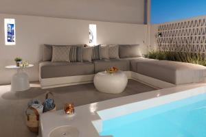 a living room with a couch and a swimming pool at Vivant Naousa Residence 1 in Naousa