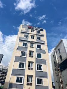 a tall building with a sign on the top of it at Wildwings hotel in Hyderabad