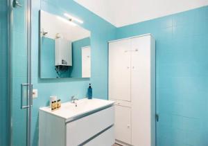 a bathroom with a white sink and blue walls at Spagno li's House in Naples +17 photos