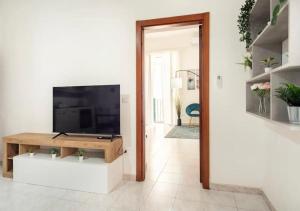 a living room with a flat screen tv on a tv stand at Spagno li's House in Naples