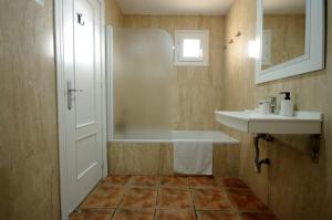 a small bathroom with a shower and a sink at Livingtarifa Chalet La Caracola in Tarifa +26 photos