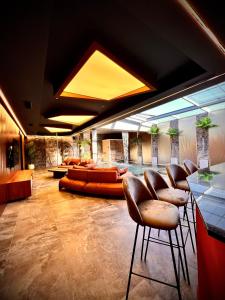 a lobby with leather chairs and a pool at Motel Villa Princi in Kosovo Polje +133 photos