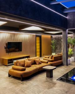 a living room with couches and a flat screen tv at Motel Villa Princi in Kosovo Polje