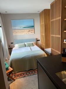A bed or beds in a room at 203 Estudio Suite Tranquilo