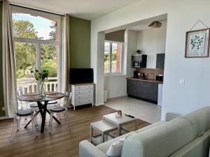 a living room with a couch and a table at Le Rivage in Yport