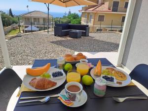 a tray of breakfast food on a table on a patio at B&B Clarosa in Pizzo