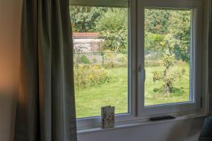 a window with a view of a garden at de Bosuil in Steensel +10 photos