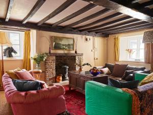 a living room with couches and a fireplace at The Castle, Capel-y-Ffin, The Black Mountains in Abergavenny