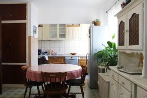 a kitchen with a table and chairs and a refrigerator at Apartments Lucia in Supetar
