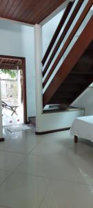 a living room with a staircase in a house at Flat, Refúgio Beira Mar in Santa Cruz Cabrália
