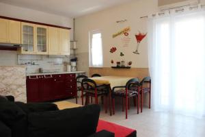 a kitchen with a table and chairs in a room at Apartments Lucia in Supetar +16 photos