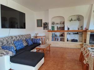 a living room with a couch and a fireplace at Alojamiento Árdales in Frailes