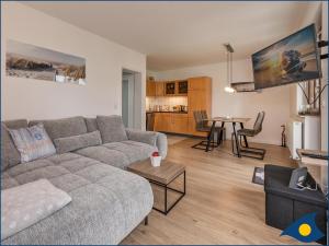 a living room with a couch and a table at Ferienwohnung Hornig in Garz-Usedom