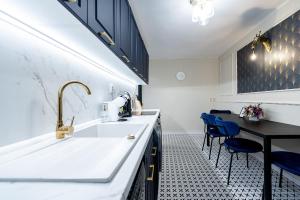 a kitchen with a sink and a table and chairs at Luxusný apartmán pri nemocnici in Košice +41 photos