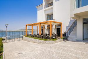 a building with a patio with tables and chairs at Portimão Ocean Breeze With Pool by Homing in Lagoa