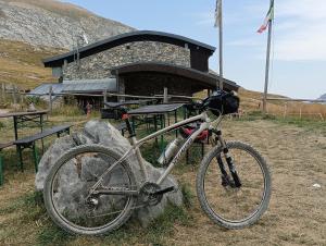 a bike parked on a rock in front of a building at La Cà ët Mec in Robilante