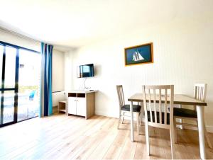 a dining room with a table and chairs at Caporizon-l'Archipel-T1-Piscine-centre ville-Terrasse in La Rochelle