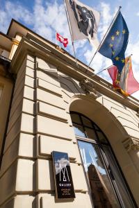 a building with three flags on top of it at Royal St. Georges Hotel Interlaken - MGallery Collection in Interlaken