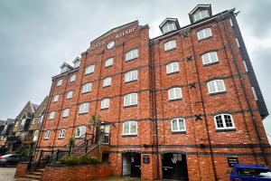 a large red brick building with white windows at The Wharf - Marina Retreat in Pevensey
